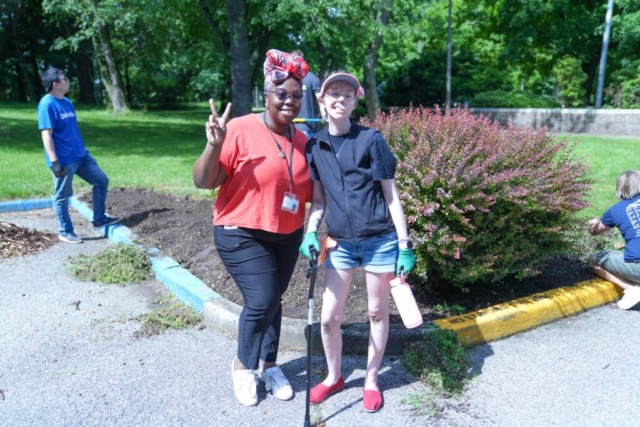 A female HKNC staff member and a female participant smile for a photo together.