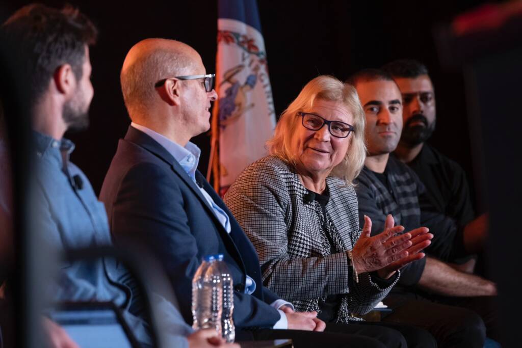 Helen Keller services CEO Sue Ruzenski sits alongside David D'Arcangelo and Doug Roland during a panel discussion about DeafBlind representation and the Feeling Through Studio learning platform during the NIB Conference.